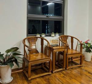 duas cadeiras e uma mesa em frente a uma janela em The Memory Villa - Mộc Châu em Mộc Châu