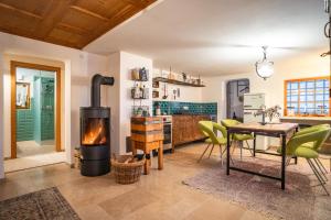 a living room with a fireplace and a table at Chalet Frederik in Fontanella