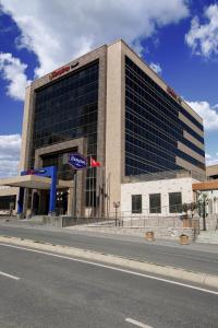 a building on the side of a street at Hampton by Hilton Istanbul Kayasehir in Istanbul