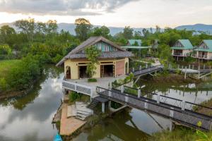 a house on a bridge over a river at Kampot Eco Village in Kampot