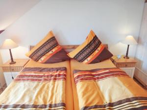 a bedroom with two beds with pillows on them at Fischreiher 2 in Kappeln