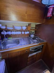 a kitchen with a sink and a stove and plates at El Velero in Puerto Calero