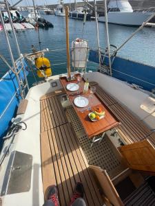 a table on the deck of a boat in the water at El Velero in Puerto Calero