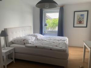 a bedroom with a bed and a window at Möwe in Kappeln +14 photos