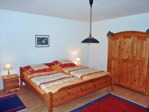 a bedroom with a wooden bed in a room at Möwe in Kappeln