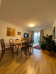 a living room with a dining room table and chairs at ElegantLiving Graz, free parking in Graz