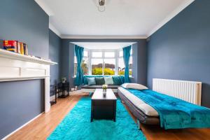 a blue bedroom with a bed and a fireplace at UKSAS Two bed house Free Parking in Redbridge