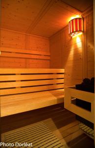 a wooden sauna with a bench and a lamp at Manoir François 1er in Vitry-le-François