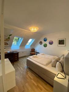 a bedroom with a large bed and a desk at ElegantLiving Graz, free parking in Graz