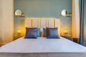 a bedroom with a large bed with blue pillows at Quiet Point in Porto