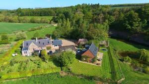 an aerial view of a large house on a green field at Old Mill Cottage in Kelso