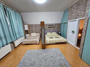 2 camas en una habitación con cortinas azules en Relax & Wellness Villa Diósd en Budapest