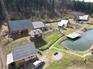 an aerial view of a group of houses with a lake at Fifth Element Retreat in Borzont