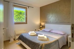 a bedroom with a bed with towels on it at Rustic villa Inga with pool and grill in Buje in Kaštel +29 photos