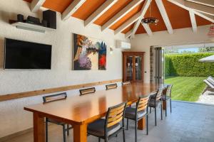 a dining room with a large wooden table and chairs at Rustic villa Inga with pool and grill in Buje in Kaštel