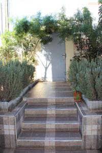 a set of stairs leading up to a white door at Belle maison avec jardin privatif in Casablanca