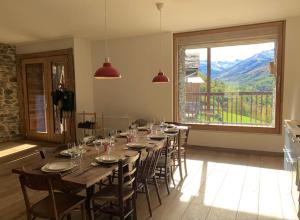 a dining room with a long table and chairs at Spacieux Chalet Authentique dans les 3 Vallées in Saint-Marcel