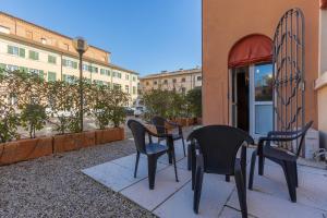 a group of chairs and tables on a patio at Dimora Storica Manfredini nel cuore di Ferrara in Ferrara