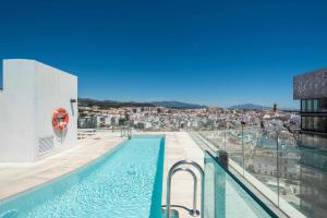a swimming pool on top of a building with a city at Selecta Estepona Roof Top Pool 3 in Estepona