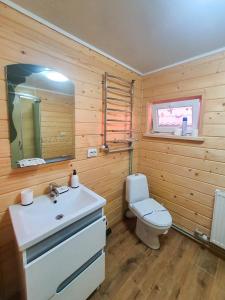 a bathroom with a white sink and a toilet at Готель Ярсон in Yaremche