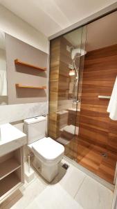 a bathroom with a toilet and a shower at Unity by Hosppedar in Penha