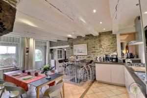 a kitchen and dining room with a table and chairs at La petite salmonais in Saint Malo