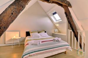 a bedroom with a bed in a attic at La petite salmonais in Saint Malo