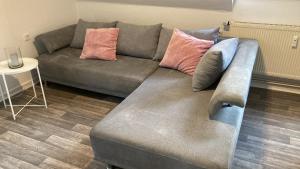 a couch with pillows on it in a living room at Balance Apartments by M&A - Train station in Witzenhausen