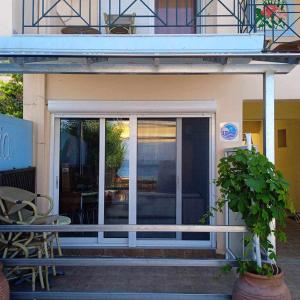 a building with a sliding glass door with a patio at ASIMENIA STUDIOS in Achladi