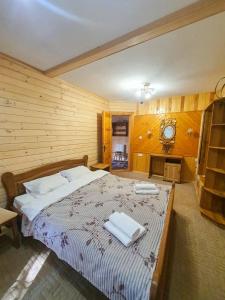 a bedroom with a large bed with towels on it at Готель Ярсон in Yaremche