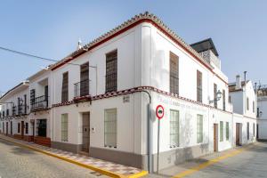 a white building on the side of a street at La Casa del Convento in Villamanrique de la Condesa