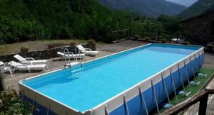 a large swimming pool with a view of a mountain at Casa Lavanda in Pescaglia
