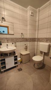 a bathroom with a sink and a toilet at Apartman SUNCE in Trebinje +24 photos