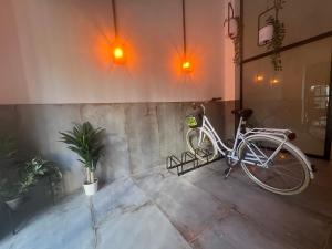 a bike parked next to a wall with two lights at Niña Mala in Valencia