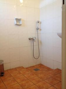 a bathroom with a shower with a shower head at Aegli Hotel in Athens