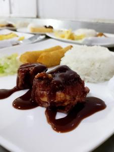 a plate of food with a piece of cake and rice at SGH hotel Mathilu Rodadero in Santa Marta