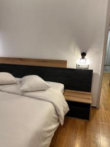 a bedroom with two beds and a table with a lamp at Hotel Nefeli in Volos