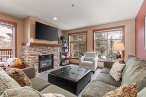 a living room with a couch and a fireplace at Powderhorn Lodge 210: Blazing Star Suite in Solitude