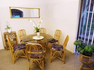 a dining room with a table and chairs and a mirror at Scarborough & Absolutely Beachfront in Perth