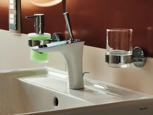 ein Waschbecken mit einem Wasserhahn und einem Glas darauf in der Unterkunft Luxus Apartment mit Blick über Erfurt im Zentrum in Erfurt