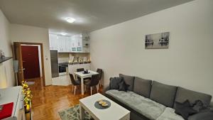 a living room with a couch and a table at Apartman SUNCE in Trebinje