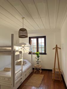 a bedroom with a white bunk bed and a window at La Posada Coliving in Viña del Mar