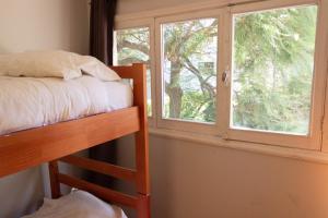 a bedroom with a bunk bed and a window at BBCasita in Santiago