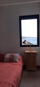 a bedroom with a bed and a window with a bird at Villa Troc Pinell in Banyuls-sur-Mer
