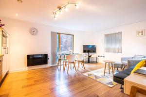 a living room with a couch and a table at Stylish 2 Bed City Centre Apartment with Sofa Bed - FREE Parking, Espresso Machine, Netflix, Alexa in Sheffield