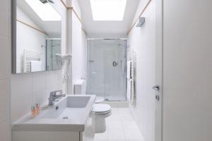 a bathroom with a sink and a toilet and a shower at Adriano Residence in Bologna