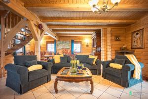 a living room with couches and a coffee table at Dom w Górach Stołowych MyWeek in Wambierzyce