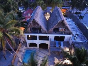 an aerial view of a house with a thatched roof at Casa Mate BeachFront HOUSES El Cuyo in El Cuyo