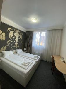 Postel nebo postele na pokoji v ubytování Hotel Stadion