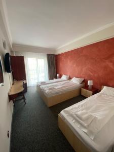 Postel nebo postele na pokoji v ubytování Hotel Stadion
